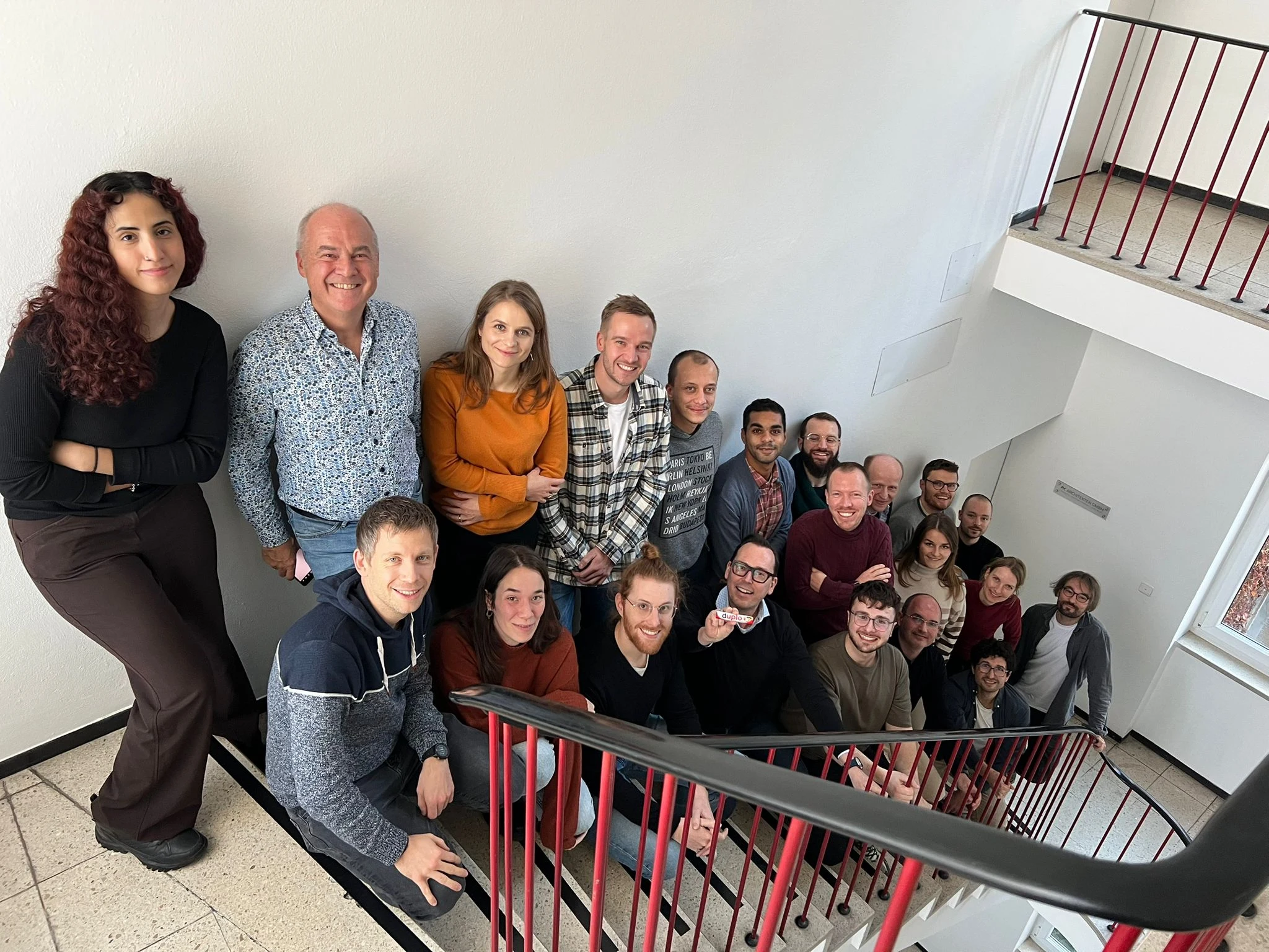 hema.to's team gathered on a staircase